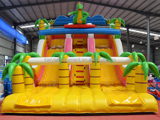 Jogos de parque ao ar livre 2 pistas Palmeira tropical PVC inflável Dinossauro Salto Salto Slide